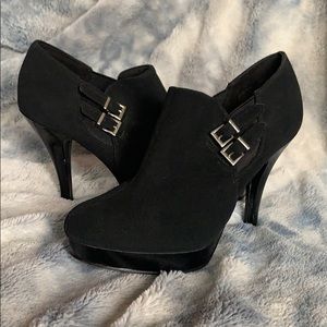 Black heeled booties with silver buckles